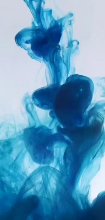 Abstract blue ink swirling on light background.