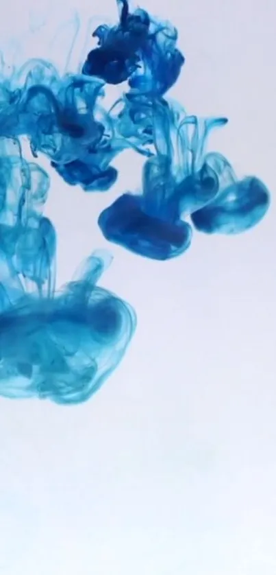 Blue ink swirling in water against a white background.