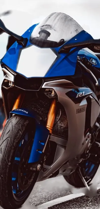 Sleek blue motorcycle on urban street wallpaper.