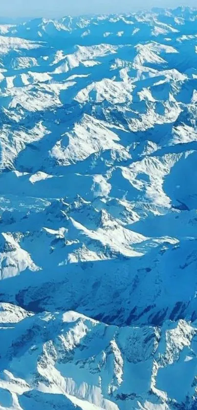 Aerial view of blue snowy mountains.