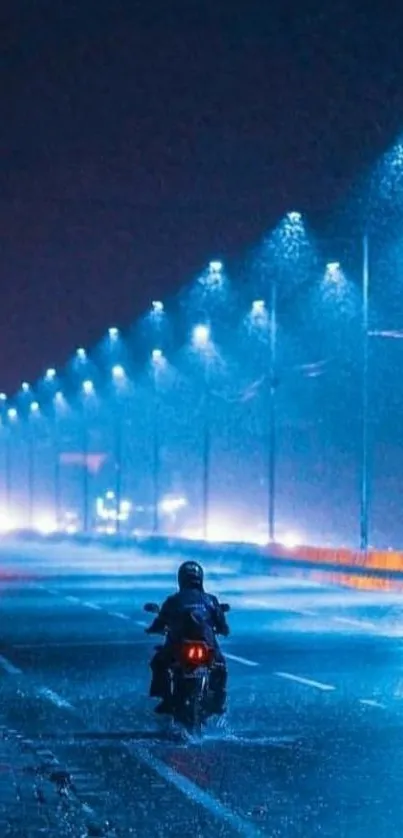 Motorcyclist rides under blue streetlights on a rainy night.