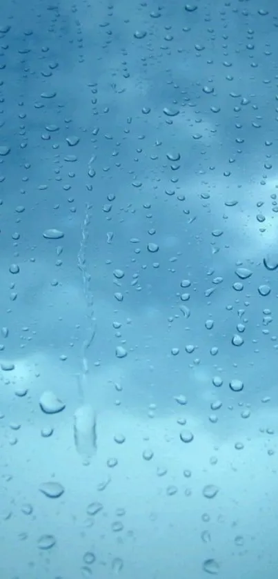 Raindrops on a window with a calming blue sky in the background.