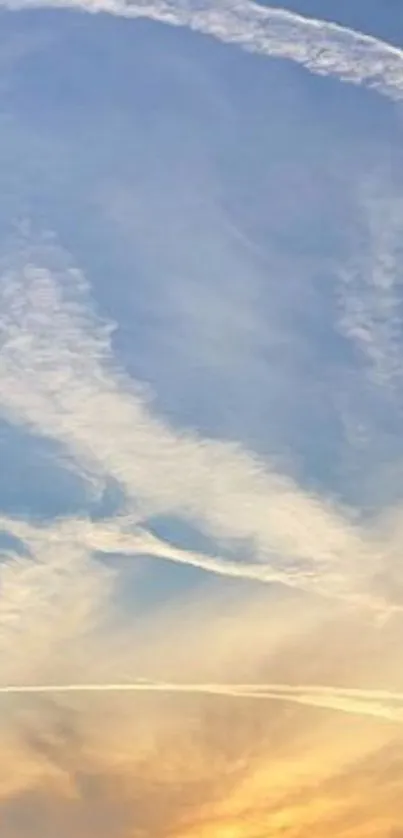 Serene blue sky with sunset hues and clouds.