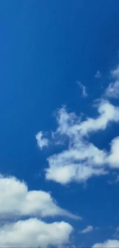 Mobile wallpaper of blue sky with fluffy white clouds.