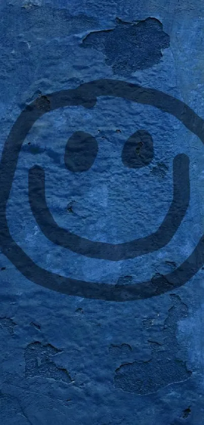 Blue textured wall with a black smiley face graffiti.