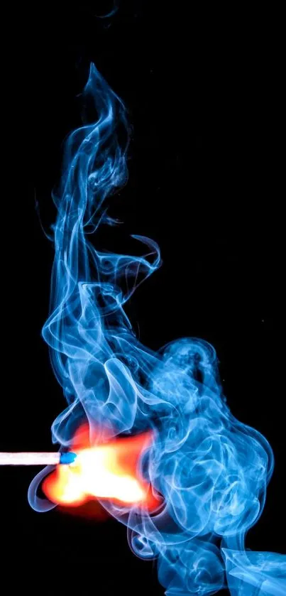 Blue smoke and bright flame on a matchstick against black background.