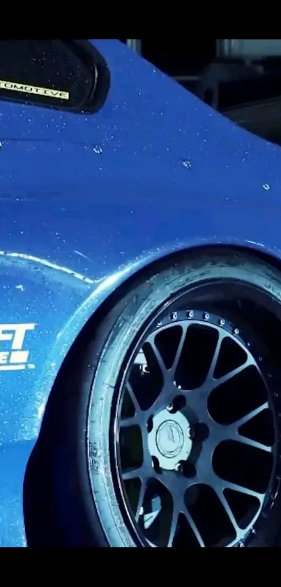 Close-up of a blue sports car with black wheels.