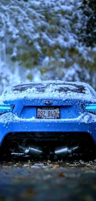 Blue sports car covered in snow in a tranquil winter scene.