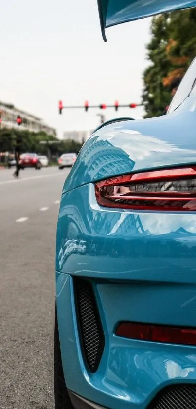 Blue sports car on urban street background.