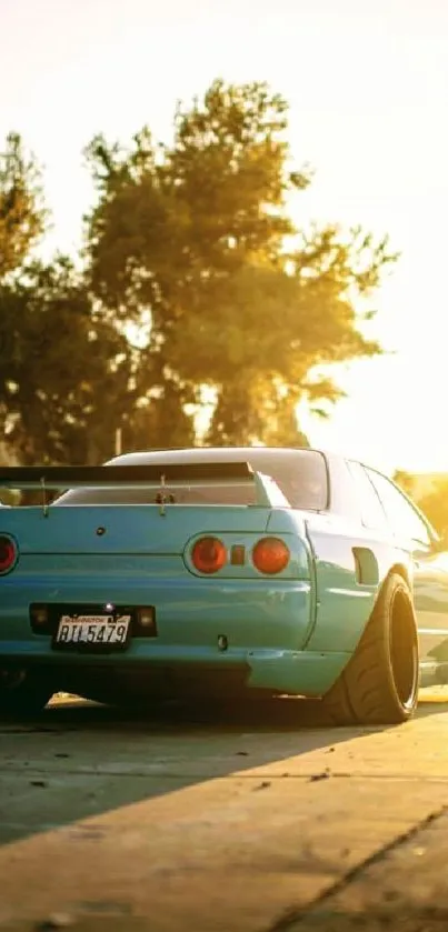 Blue sports car under a golden sunset.