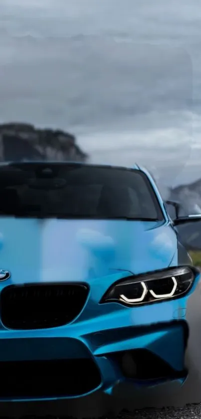 Vibrant blue sports car with mountain backdrop.