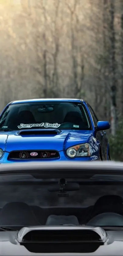 Two Subaru cars in a forest setting, emphasizing blue hues and dynamic design.