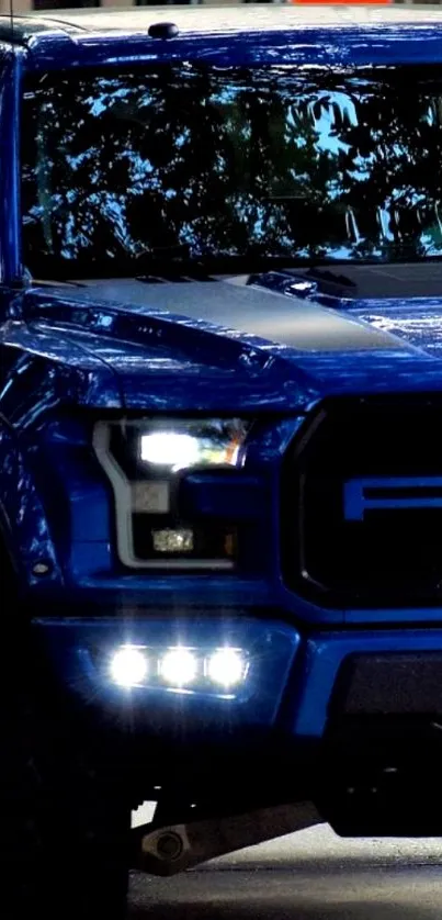 Front view of a bold blue truck in an urban setting.