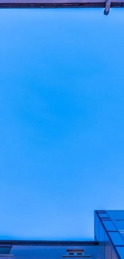 Minimalist blue sky between buildings wallpaper.