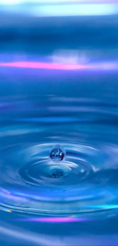 Blue water droplet creating ripples in a serene ocean background.