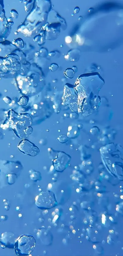 Close-up of blue water droplets floating freely in a serene sky blue background.