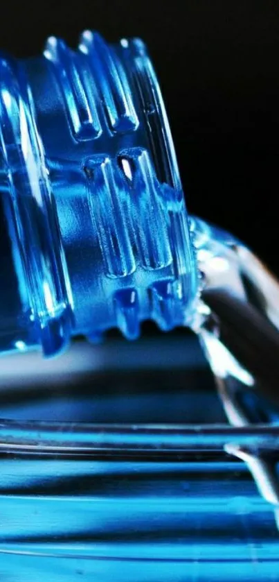 Pouring water from a blue bottle with vibrant hues for a mobile wallpaper.