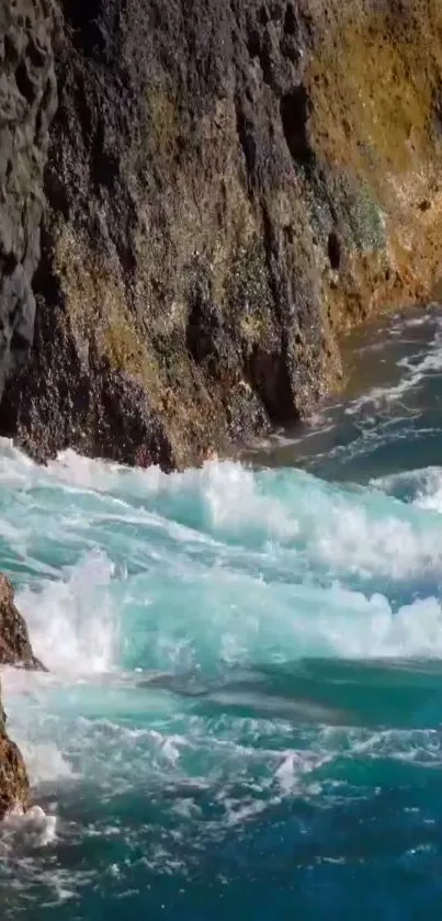 Turquoise ocean waves hit rocky cliffs on a sunny day.