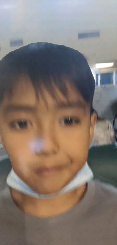 Blurred image of a young child with soft colors and gentle expression.