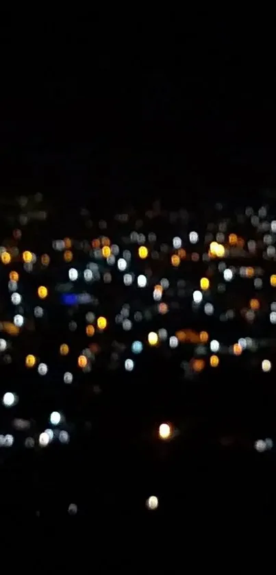 Blurry city lights at night in a bokeh style on a dark wallpaper.