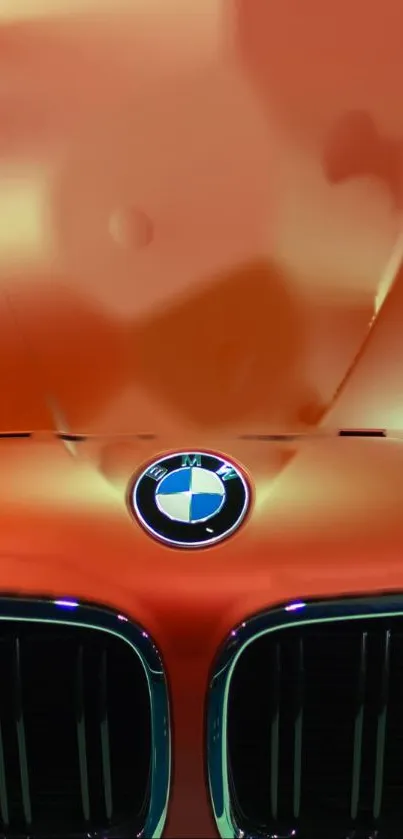 Orange BMW car hood with sleek design and emblem showcase.