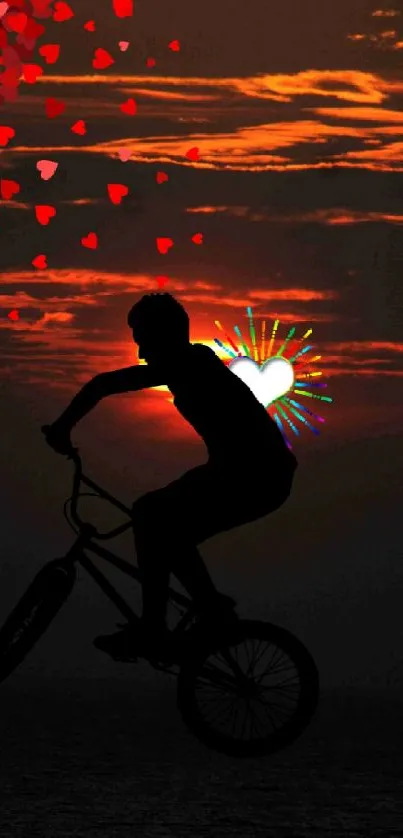 BMX silhouette with hearts against an orange sunset over water.