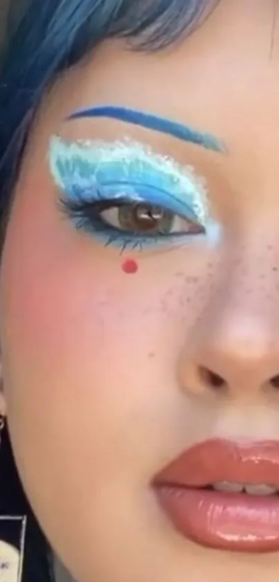 Close-up of vibrant blue artistic makeup with unique design elements.