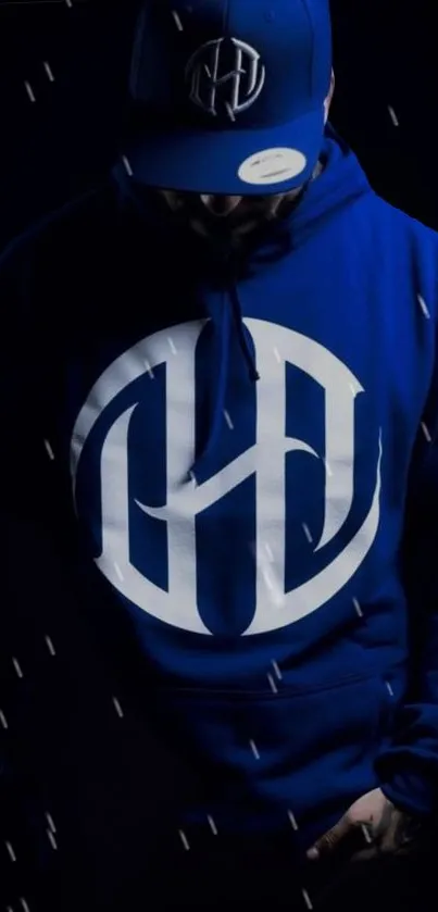 Stylish blue hoodie with logo in dark setting, ideal for mobile wallpaper.