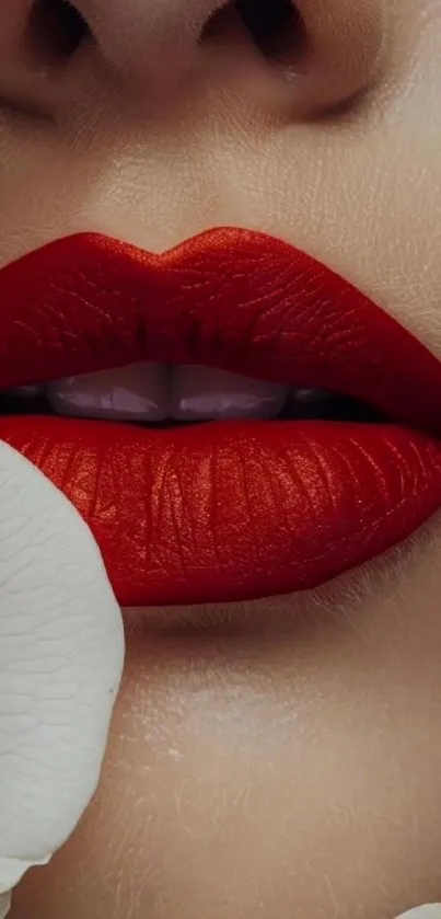 Close-up of bold red lips with white petals