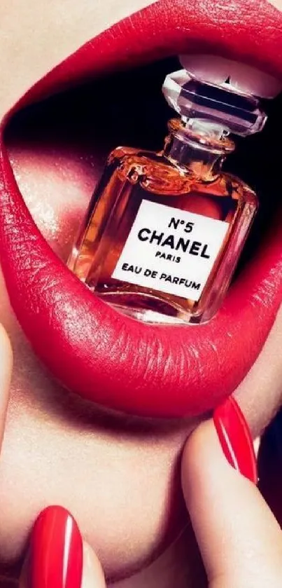 Close-up of red lips holding a Chanel No5 perfume bottle.