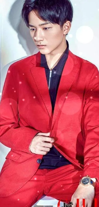 Man wearing a vibrant red suit posing against a white background.