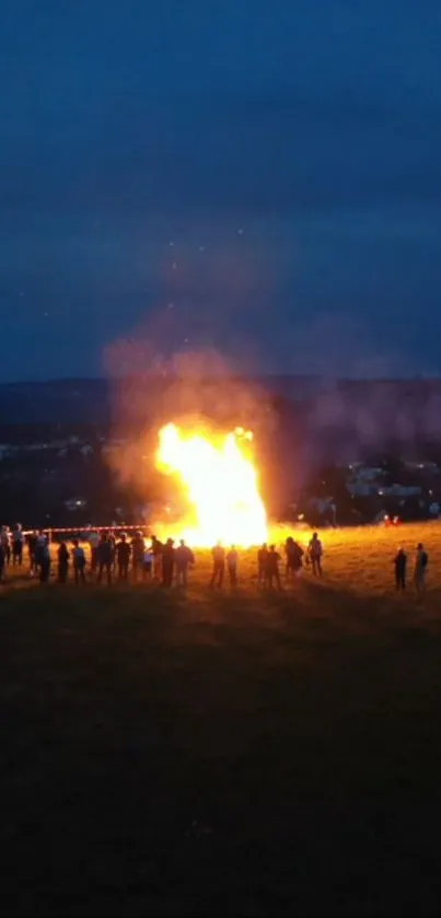 Nighttime bonfire gathering under a dark sky.