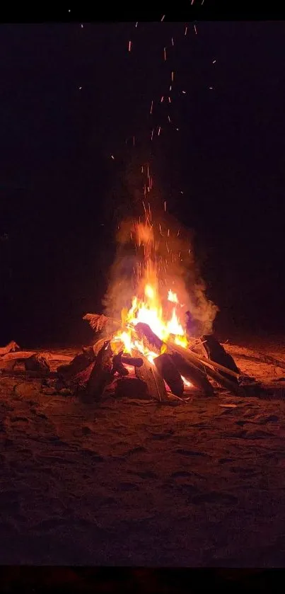 Bonfire on a sandy beach under the night sky, emitting a warm, glowing light.