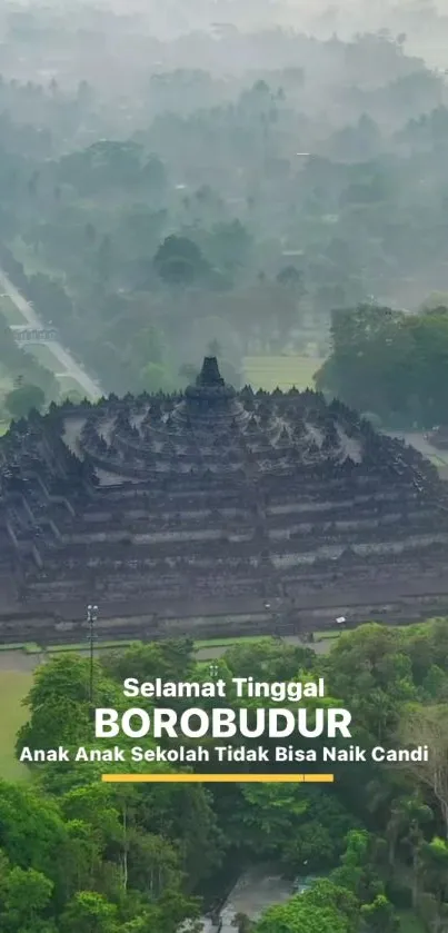 Aerial view of Borobudur Temple amidst lush greenery and misty landscape.