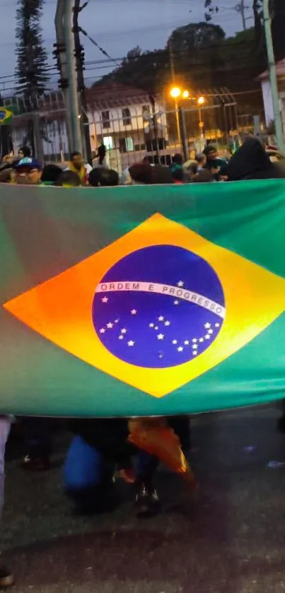 Brazilian flag held in vibrant street scene.