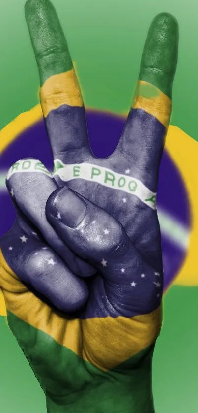 Hand showing peace sign with Brazilian flag colors.