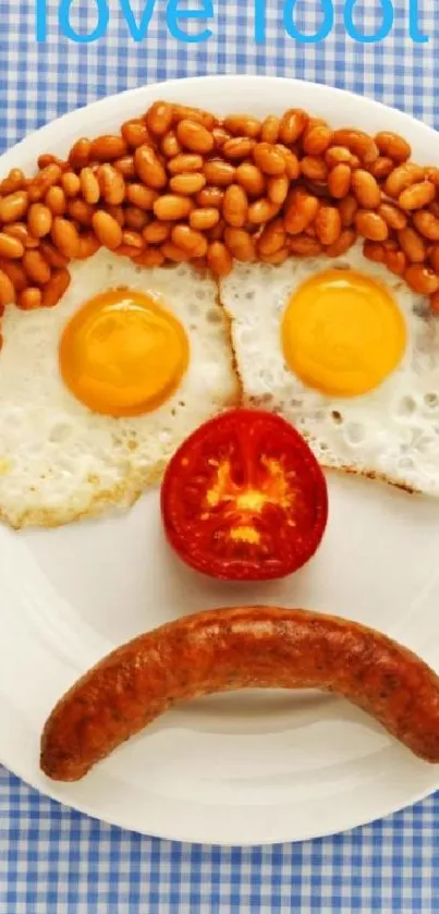 Playful breakfast face with eggs and sausage on blue checkered cloth.