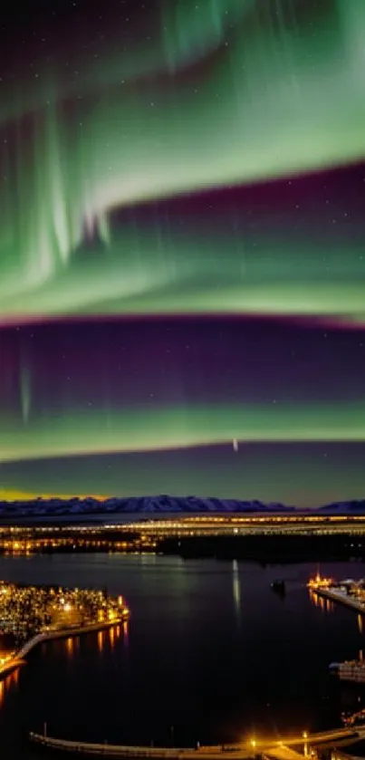 Aurora Borealis over city lights under a starry night sky.