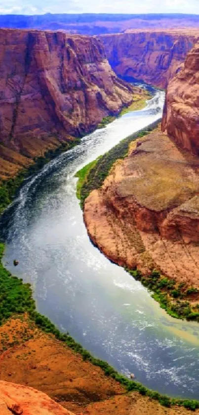 Majestic canyon with winding river in vibrant colors.