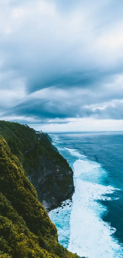 Stunning view of a coastal cliff over a vast blue ocean under a cloudy sky.