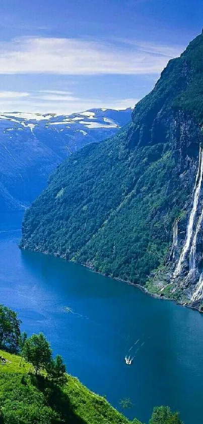 Fjord with waterfall and lush green mountains.