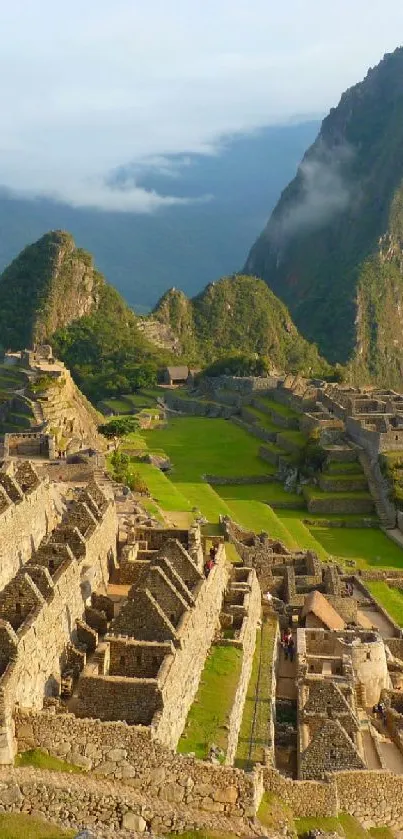 Machu Picchu ruins with green mountains in background.