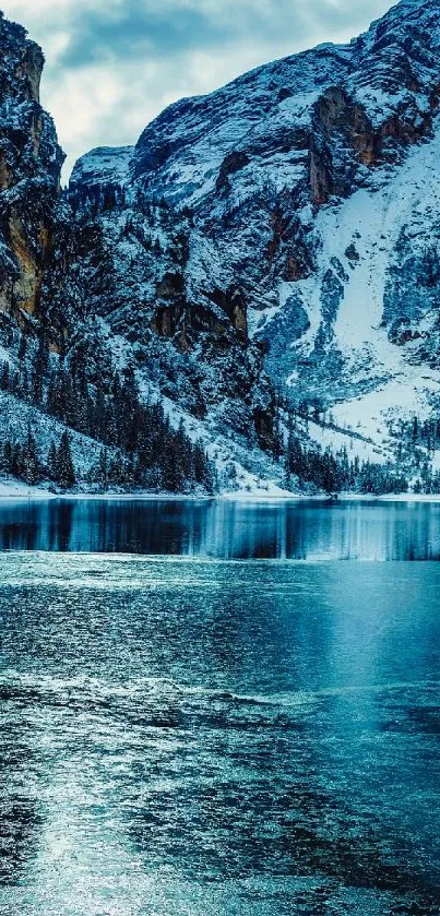 Stunning winter mountain lake with snow-capped peaks and tranquil blue waters.