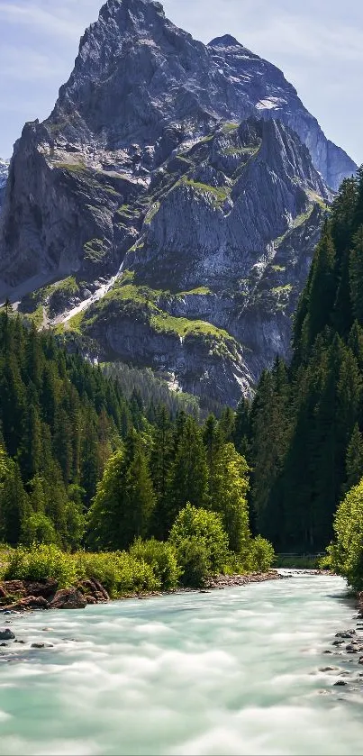 A breathtaking mountain with lush forest and a flowing river under a clear sky.