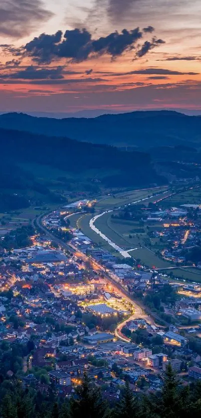 Mountain town illuminated at sunset with vibrant colors.