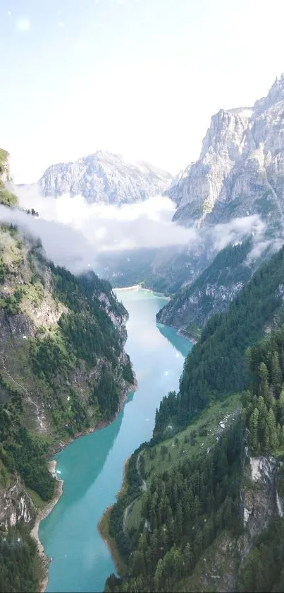 Mountain valley with blue river and green forest under a cloudy sky.