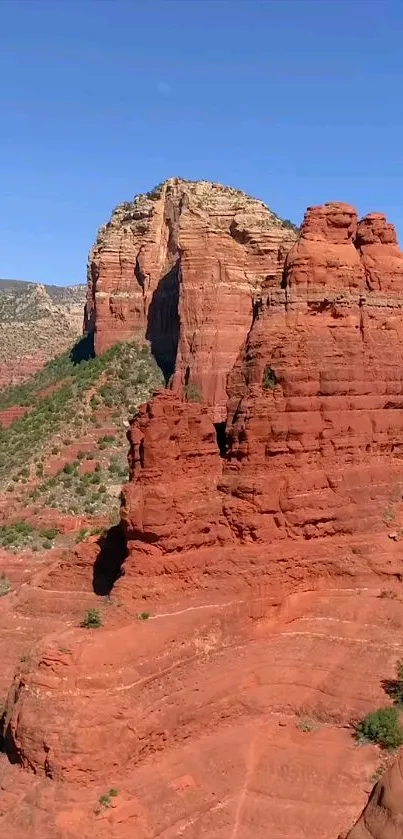 Red rock formations under clear blue sky, perfect for mobile wallpaper.