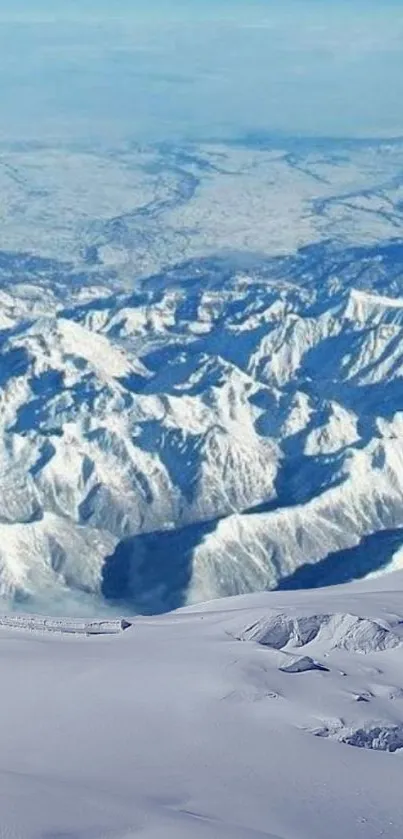 Snowy mountain landscape with blue sky.