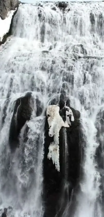 Majestic waterfall cascading down rocky terrain, creating a serene atmosphere.