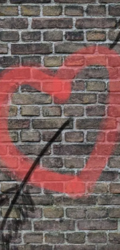 Red heart graffiti on a brick wall with an arrow.